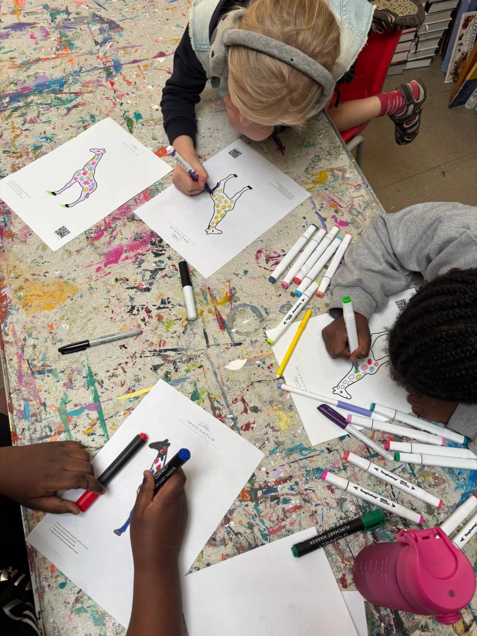 Children colouring IMAGINARIUM giraffes at a Doddz Art Pack workshop